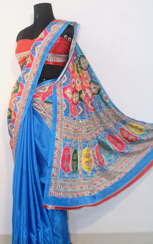 Capri blue Chinon silk saree laid flat—featuring shimmering mirror embellishments and soft, flowy texture