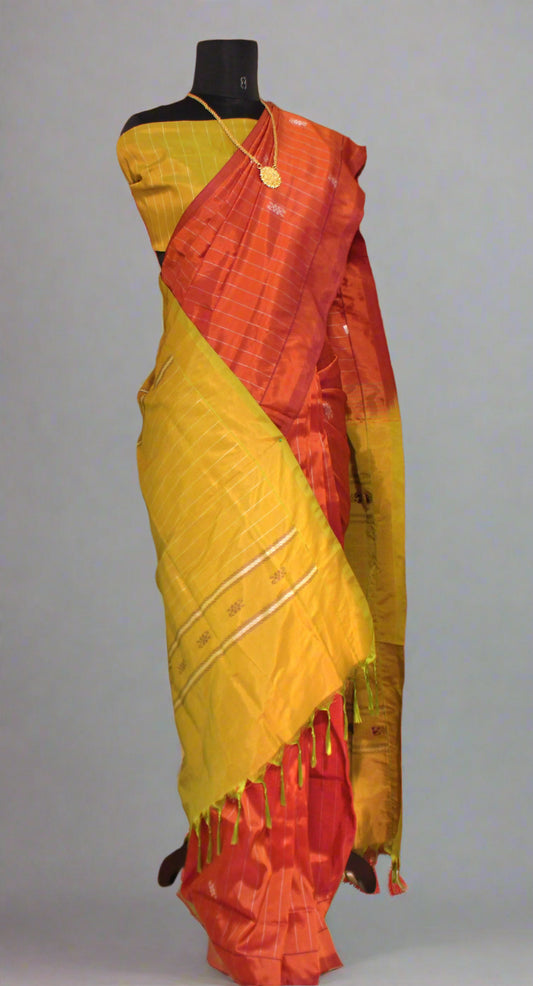 Banana Pith saree in vibrant orange with Resham lines and deep contrast pallu—styled for festive warmth and radiant tradition.