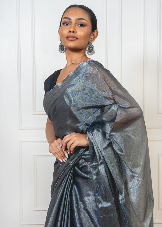 Close-up of Ash Grey Tissue Silk Saree showing fine weave, subtle shimmer, and lightweight tissue texture with zari accents.