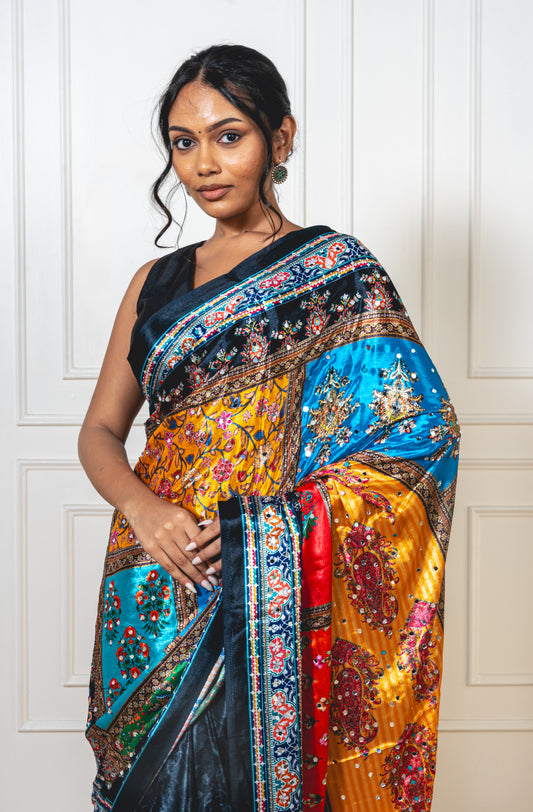 Close-up of mirror work on charcoal black Chinon silk saree—highlighting artisanal sparkle and intricate craftsmanship.