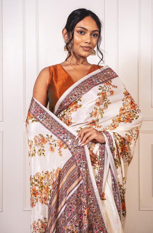 Close-up of mirror work on floral white Chinon silk saree—highlighting artisanal sparkle and delicate craftsmanship.