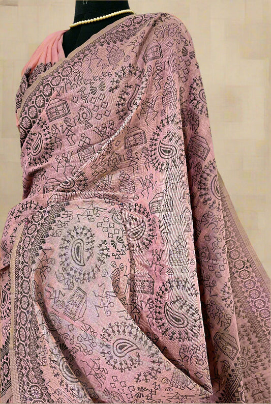 Close-up of Warli embroidery on soft pink cotton saree—highlighting tribal artistry and delicate craftsmanship.