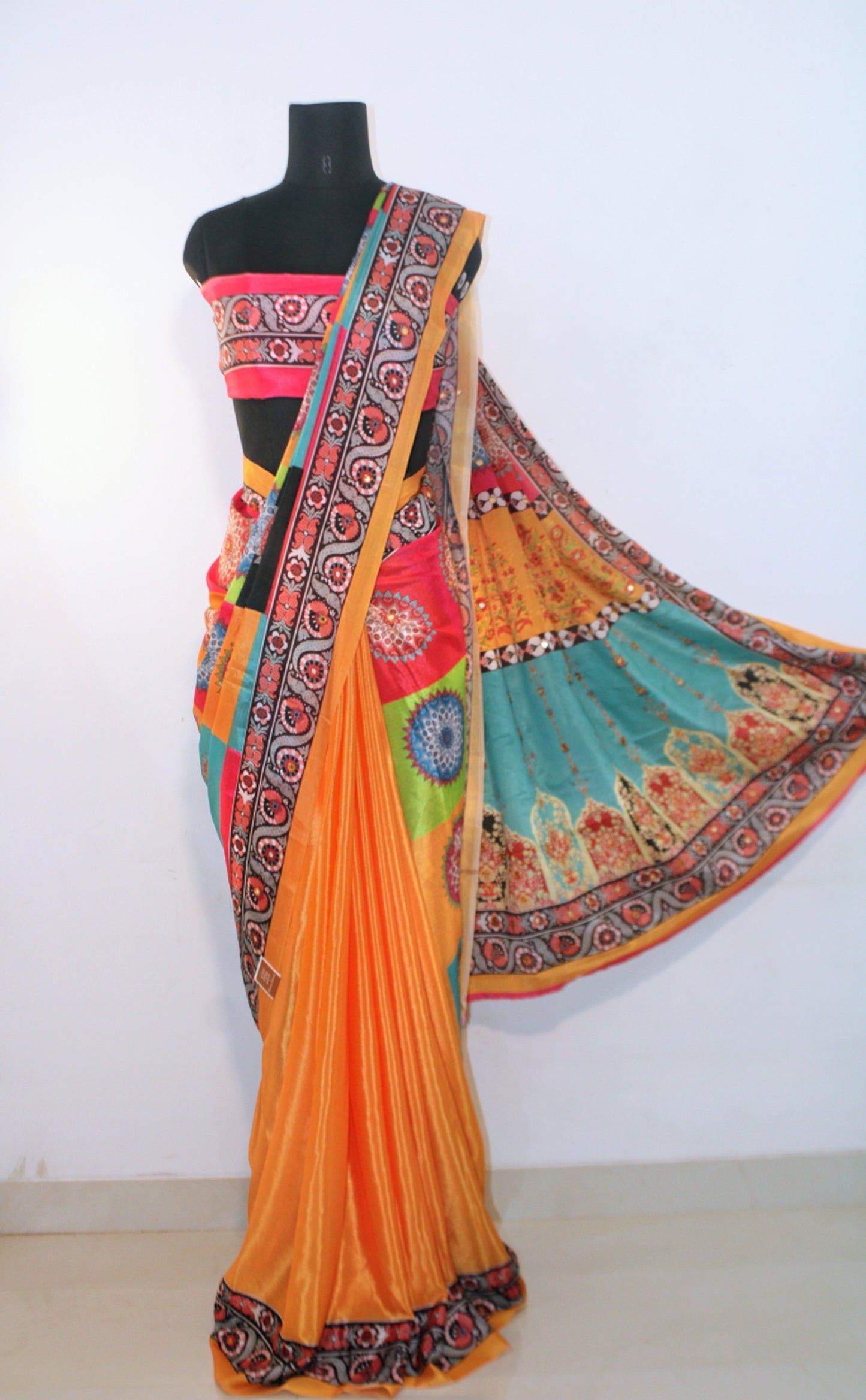 Mannequin wearing marigold yellow Chinon silk saree with mirror work—styled for Navaratri garba nights, pujas, and festive celebrations.