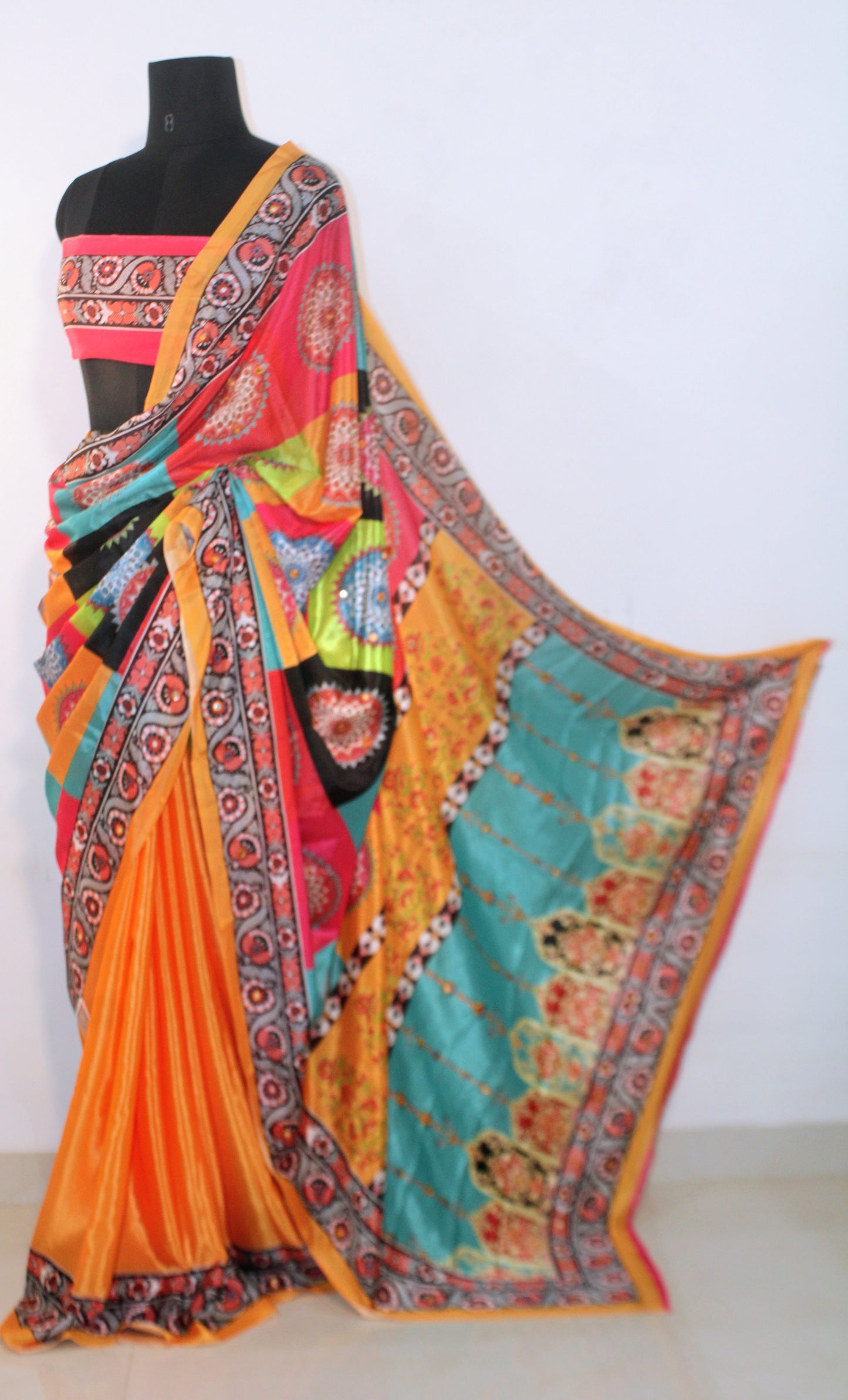 Marigold yellow Chinon silk saree with mirror-detailed pallu and crisp pleats—capturing festive shimmer and graceful movement.