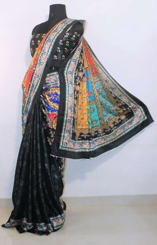 Woman wearing smoke black Chinon silk saree with mirror work—styled for Navaratri garba nights, pujas, and festive celebrations.