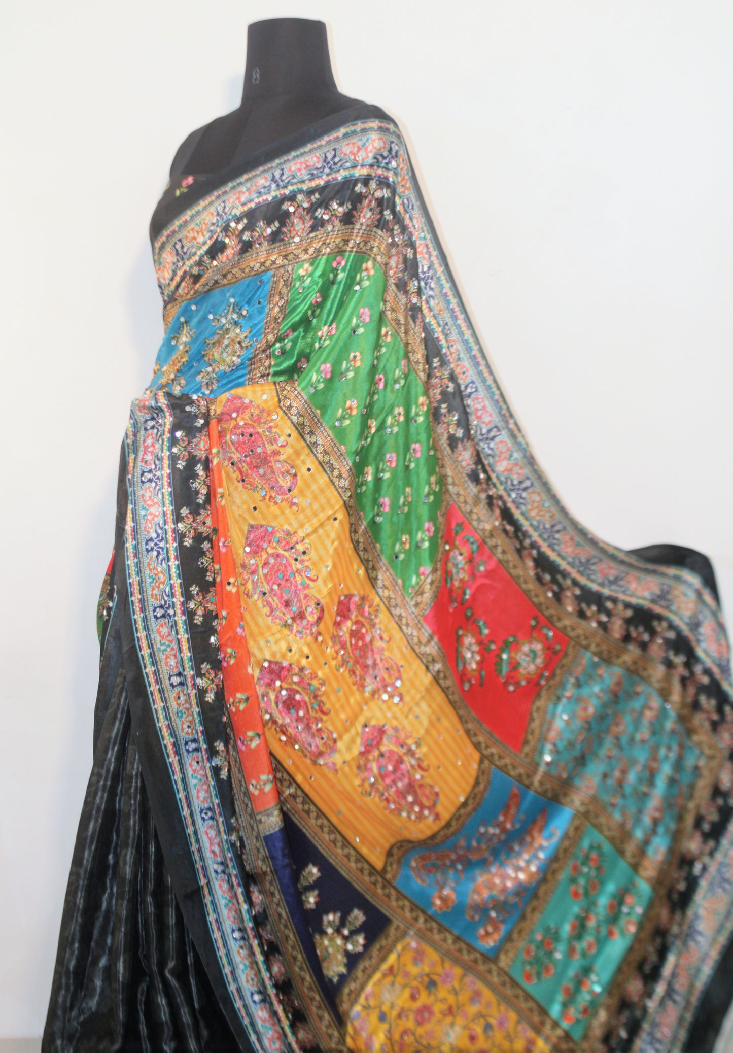 Smoke black Chinon silk saree laid flat—featuring shimmering mirror embellishments and soft, flowy texture