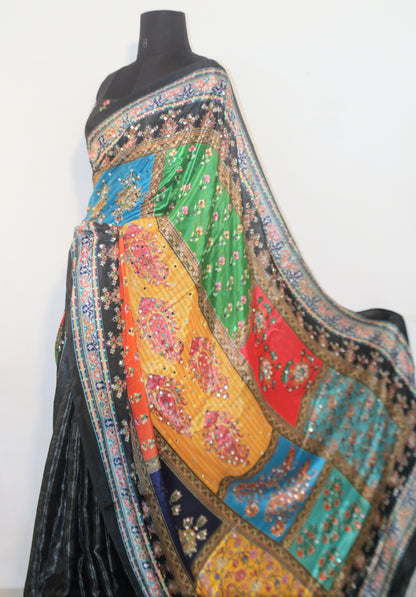 Smoke black Chinon silk saree laid flat—featuring shimmering mirror embellishments and soft, flowy texture