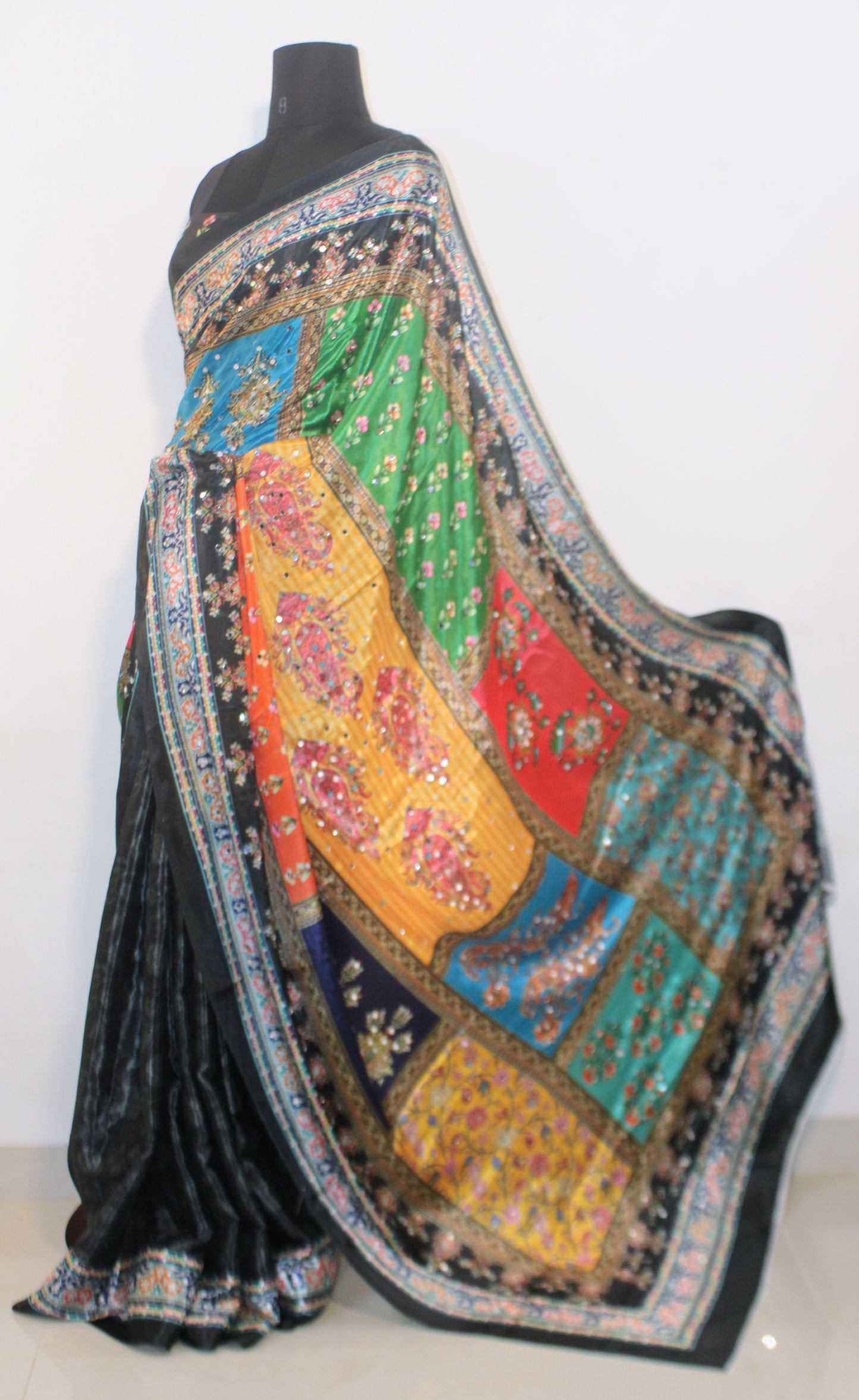 Smoke black Chinon silk saree with mirror-detailed pallu and crisp pleats—capturing festive shimmer and graceful movement.