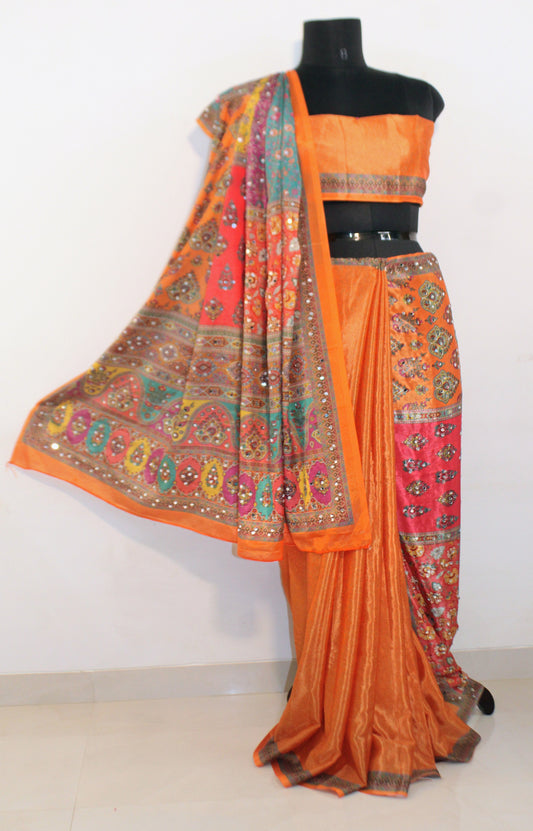 Mannequin wearing goldfish orange Chinon silk saree with mirror work—styled for Navaratri garba nights and festive celebrations.