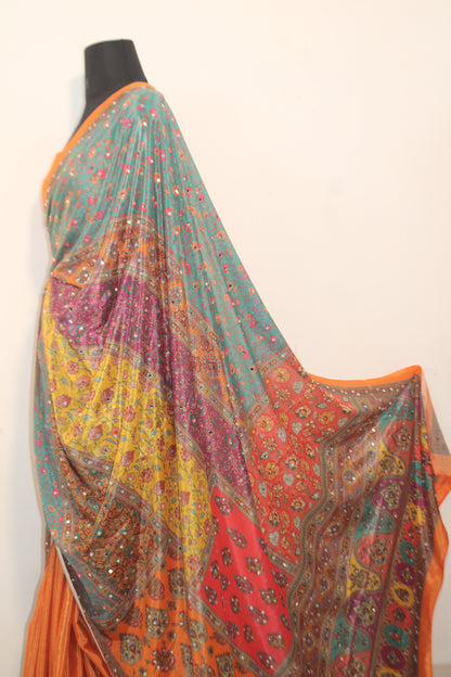 Goldfish orange Chinon silk saree laid flat—featuring shimmering mirror embellishments and soft, flowy texture