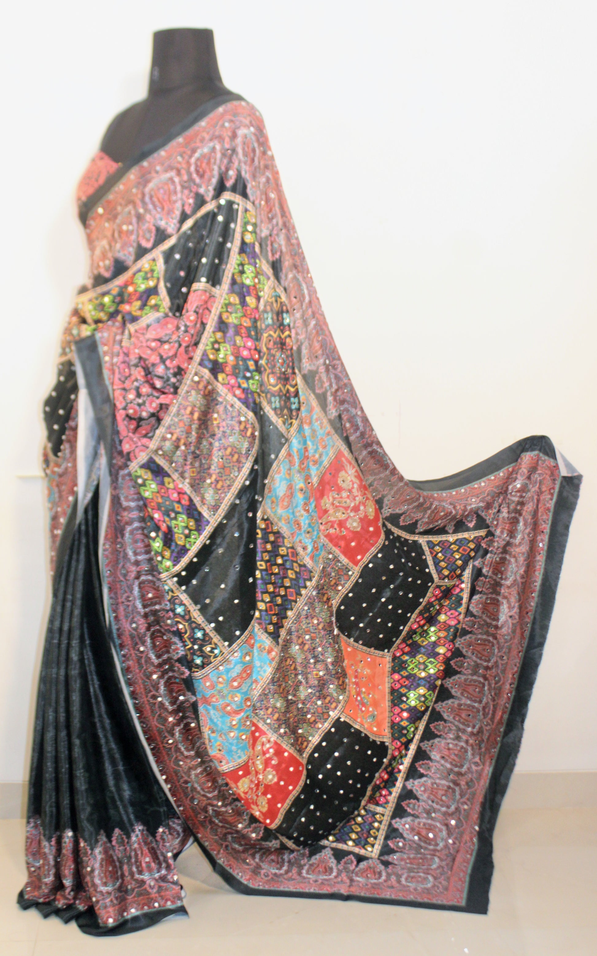Stone black Chinon silk saree laid flat—featuring shimmering mirror embellishments and soft, flowy texture