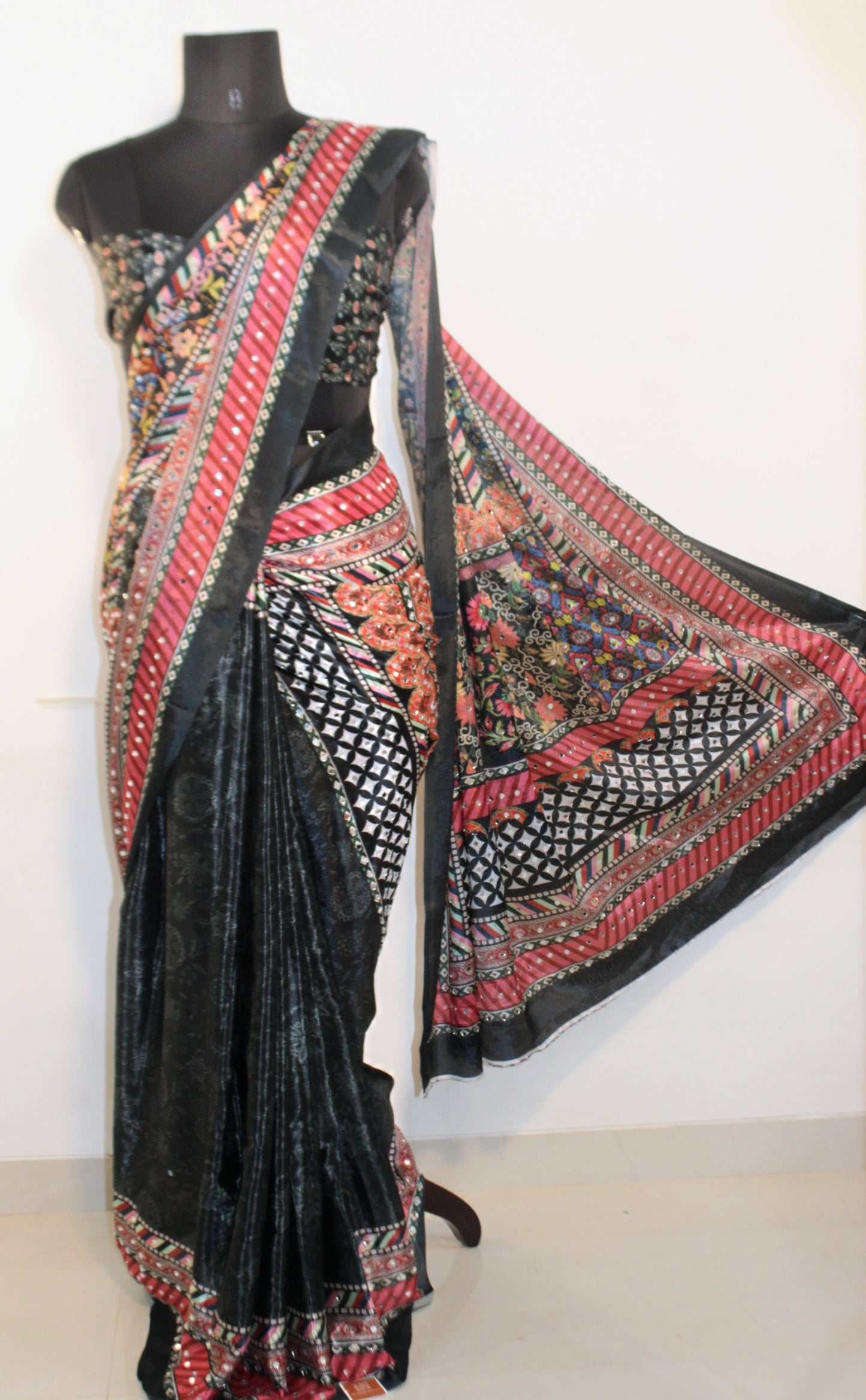 Mannequin wearing slate black Chinon silk saree with mirror work—styled for Navaratri garba nights, pujas, and festive celebrations.