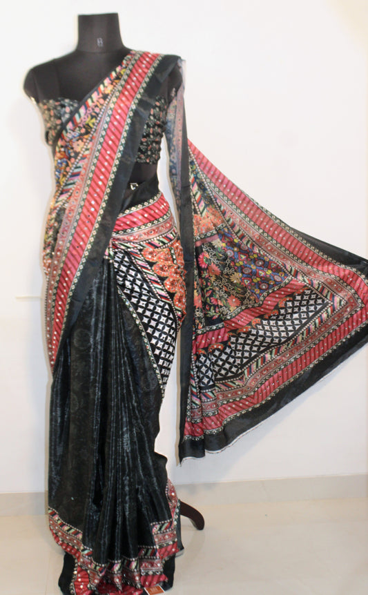 Mannequin wearing slate black Chinon silk saree with mirror work—styled for Navaratri garba nights, pujas, and festive celebrations.