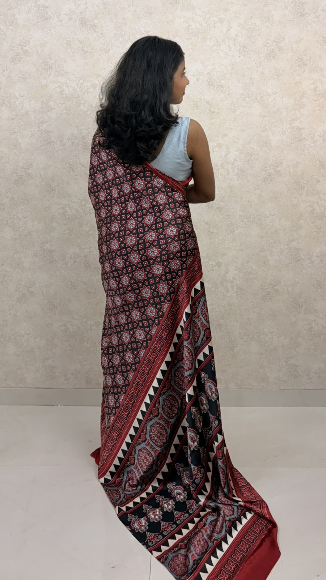Graceful pose in Modal Silk Saree featuring intricate Ajrakh Twilight design
