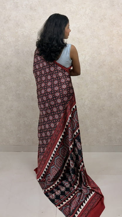 Graceful pose in Modal Silk Saree featuring intricate Ajrakh Twilight design
