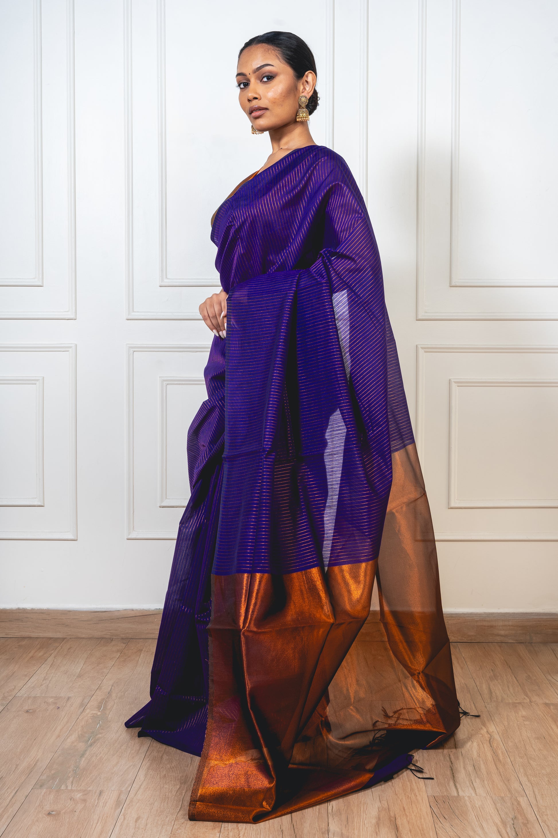 Blue Maheshwari cotton silk saree laid flat—featuring copper zari detailing, lightweight texture, and elegant sheen.