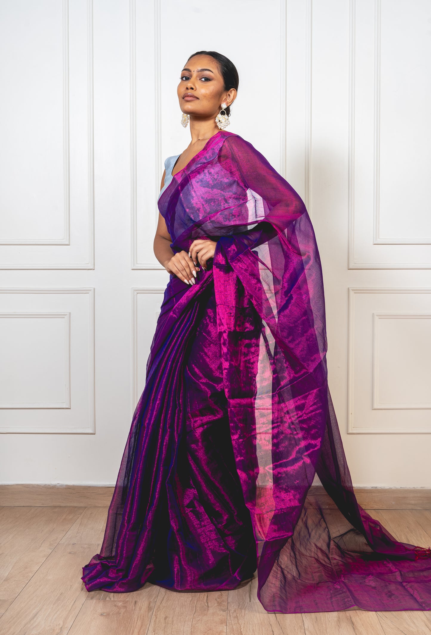 Magenta tissue silk saree with flowing pallu and crisp pleats—capturing festive finesse and regal glow