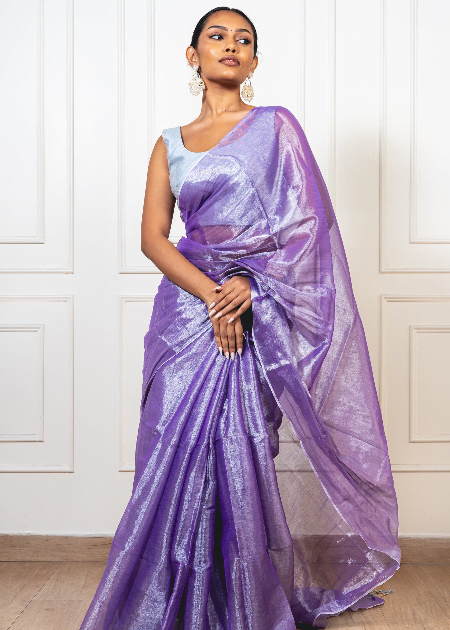 Woman wearing periwinkle purple tissue silk saree—styled for festive evenings, graceful rituals, and timeless elegance.