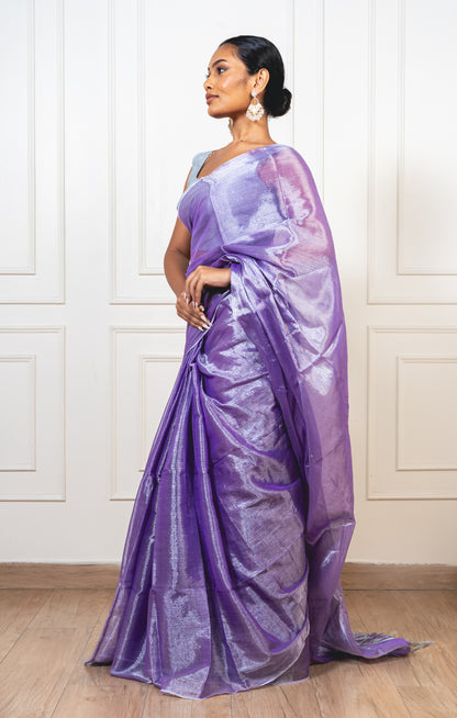 Periwinkle purple tissue silk saree with flowing pallu and radiant finish—evoking twilight softness and heirloom charm.