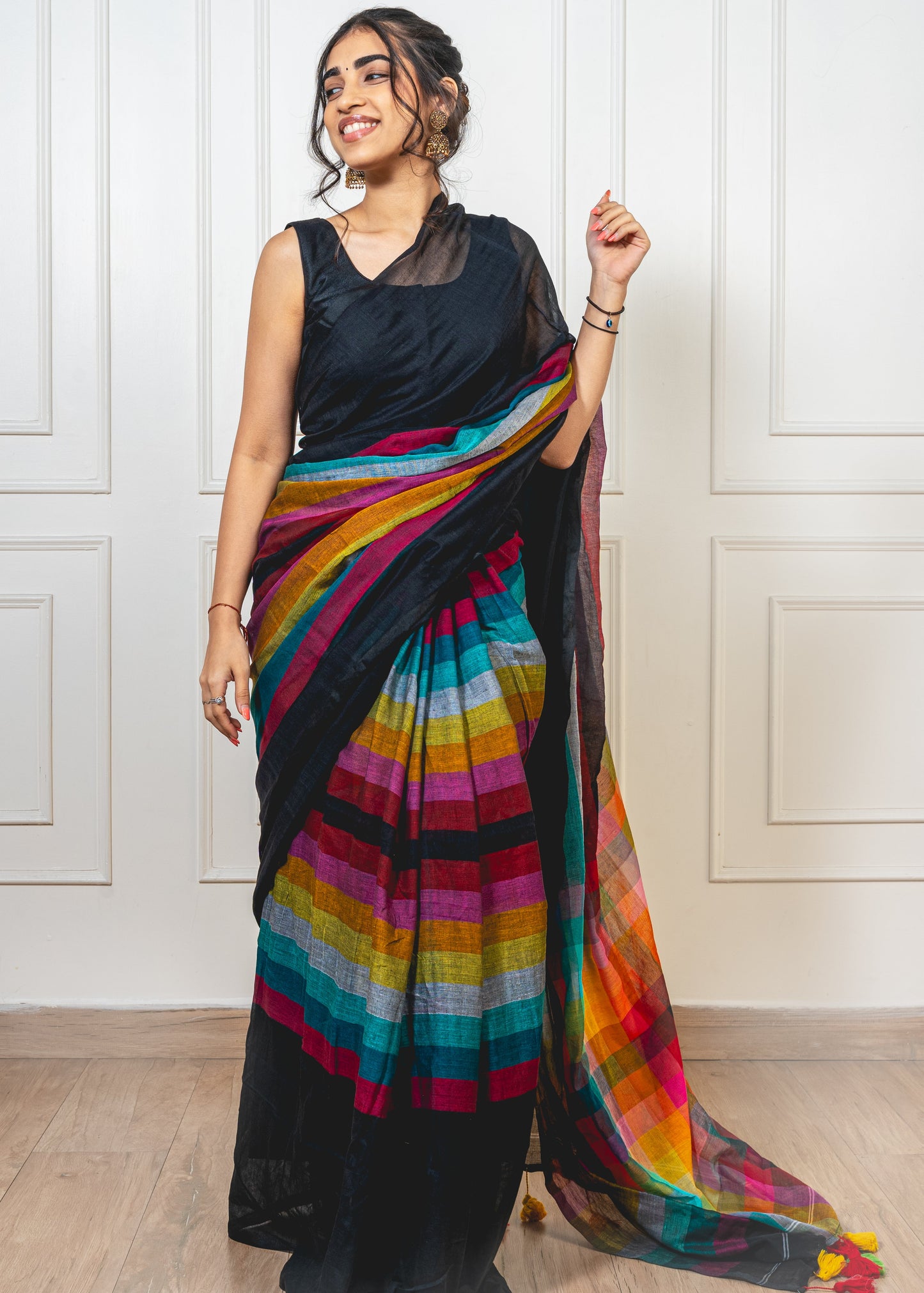 Woman wearing black Satrangi mul cotton saree—styled for everyday grace, festive charm, and vibrant tradition.