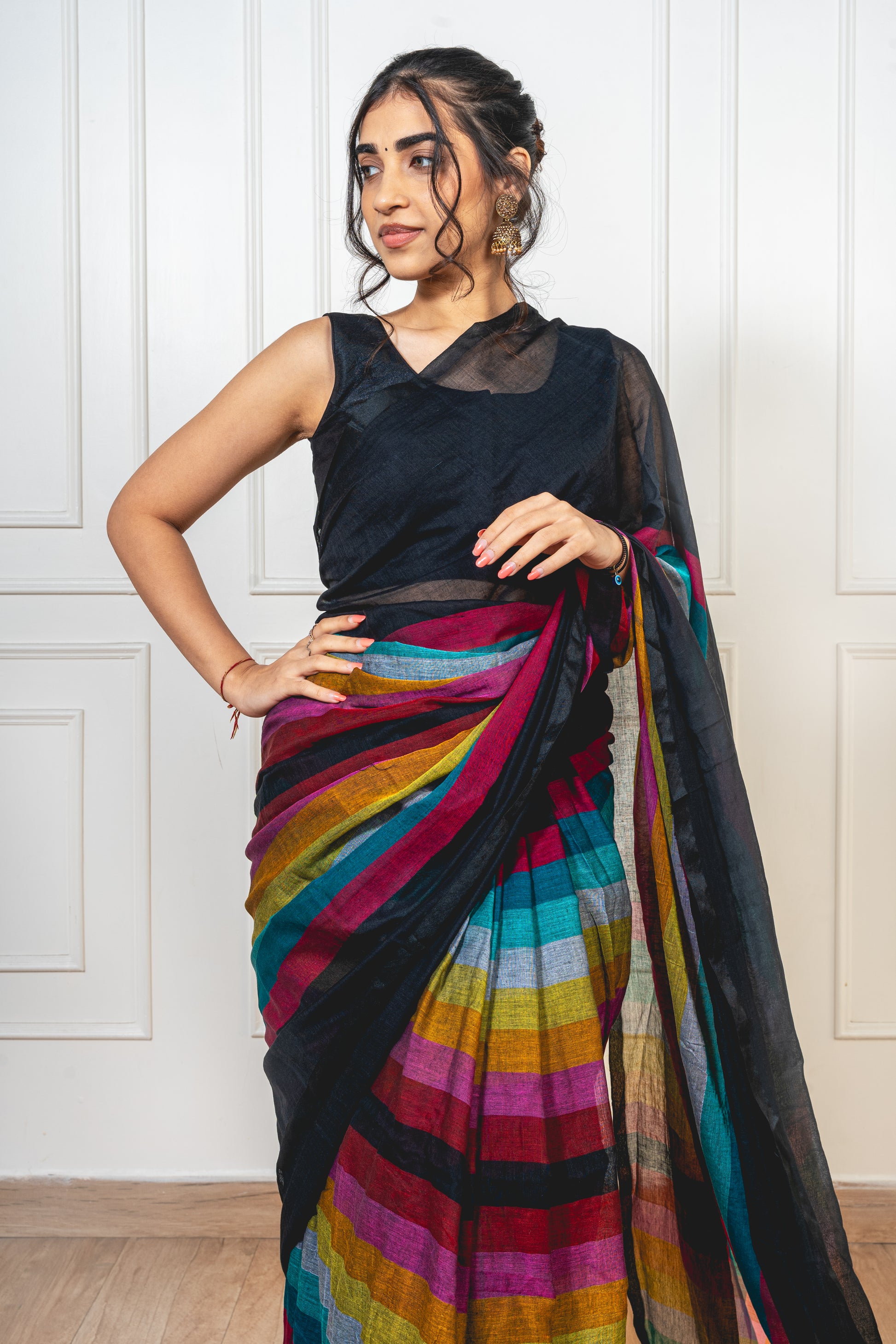 Black Satrangi mul cotton saree laid flat—showcasing soft texture and multicolor accents.