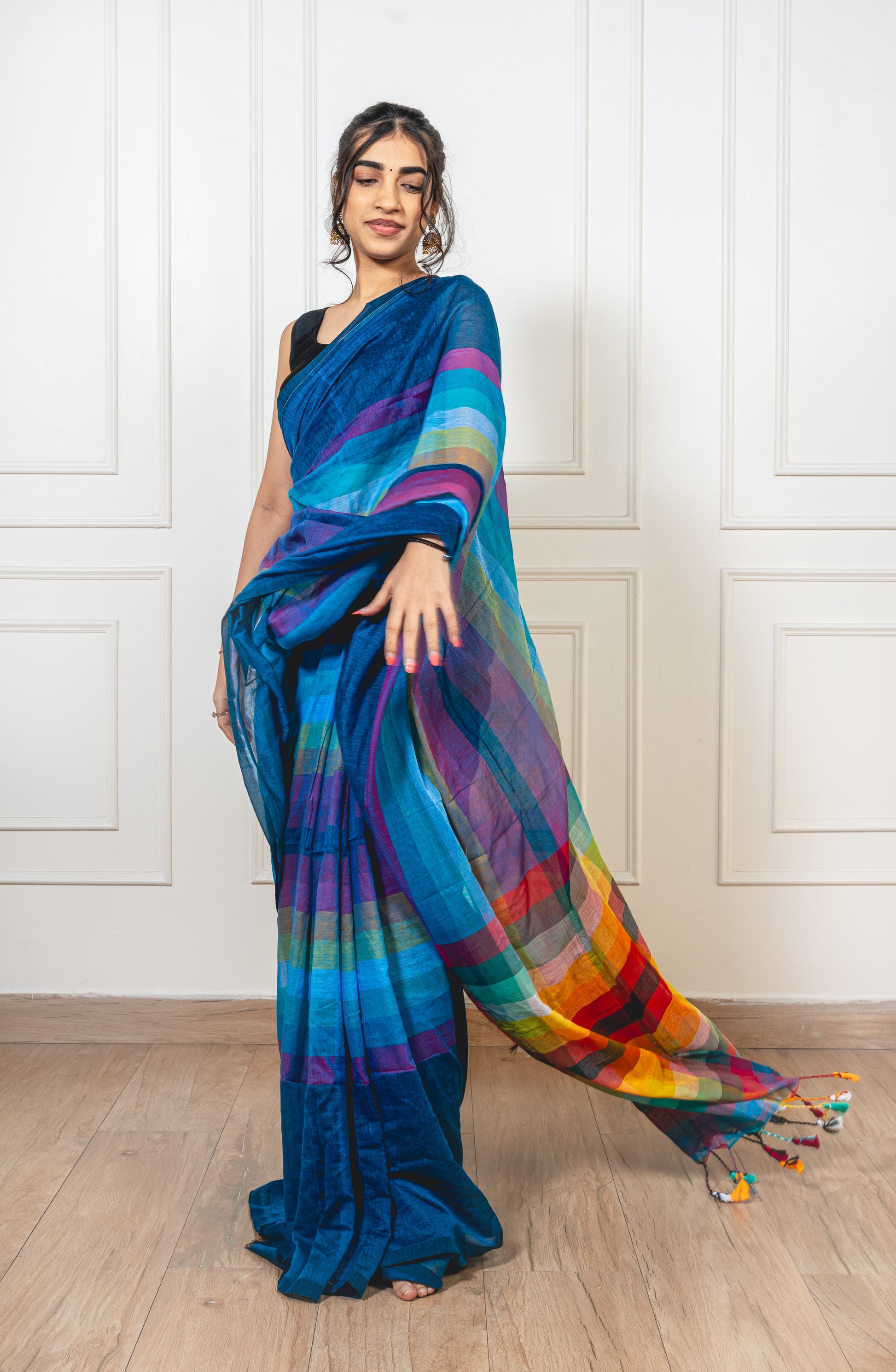 - Teal Satrangi saree featuring modern geometric motifs in rainbow hues