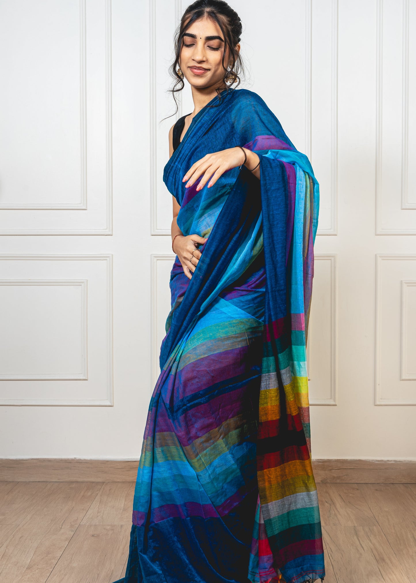 Lightweight mul cotton saree in teal with vibrant multicolor design
