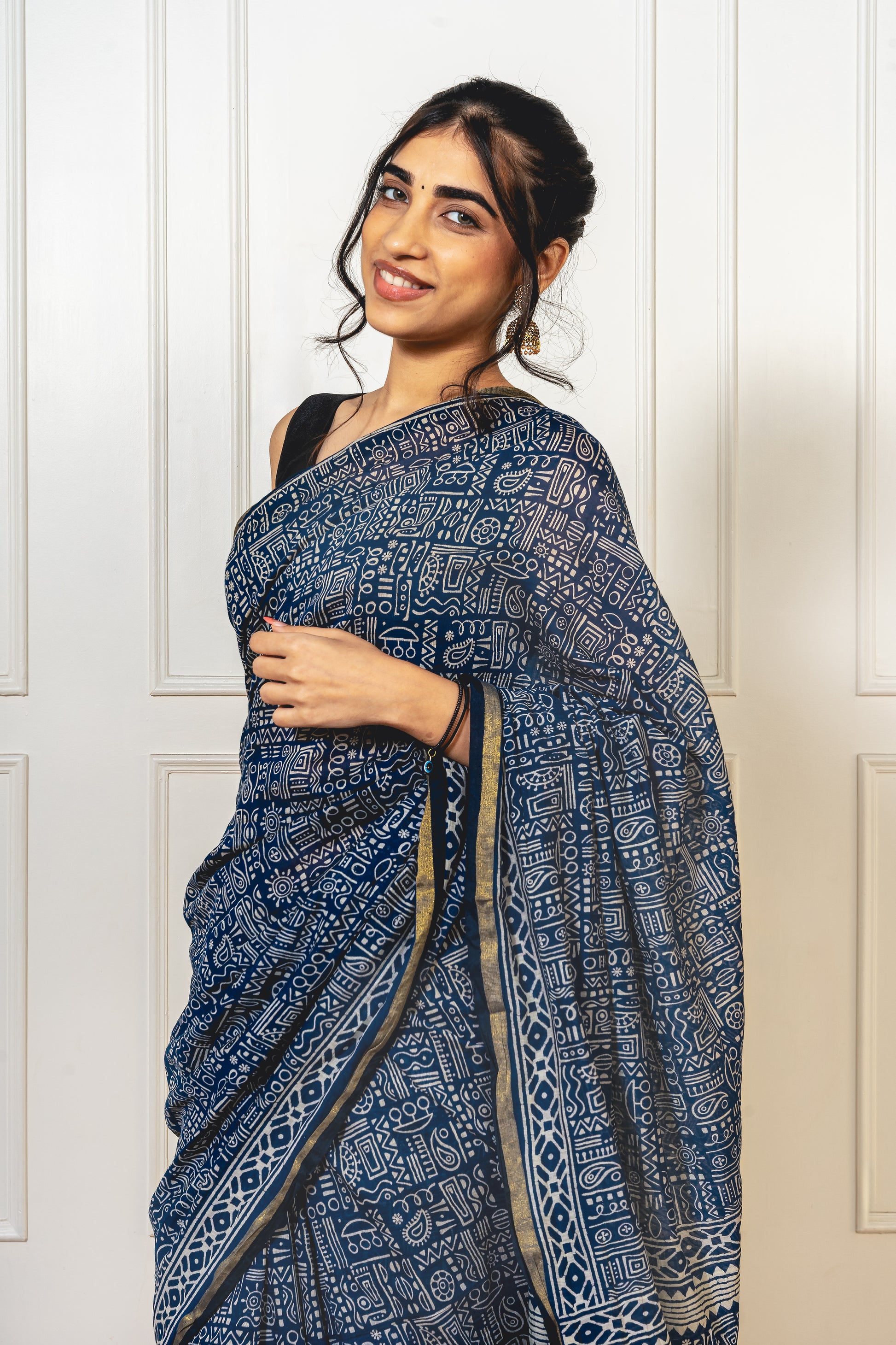 Close-up of Warli print on blue Chanderi cotton saree—highlighting tribal artistry and fine weave