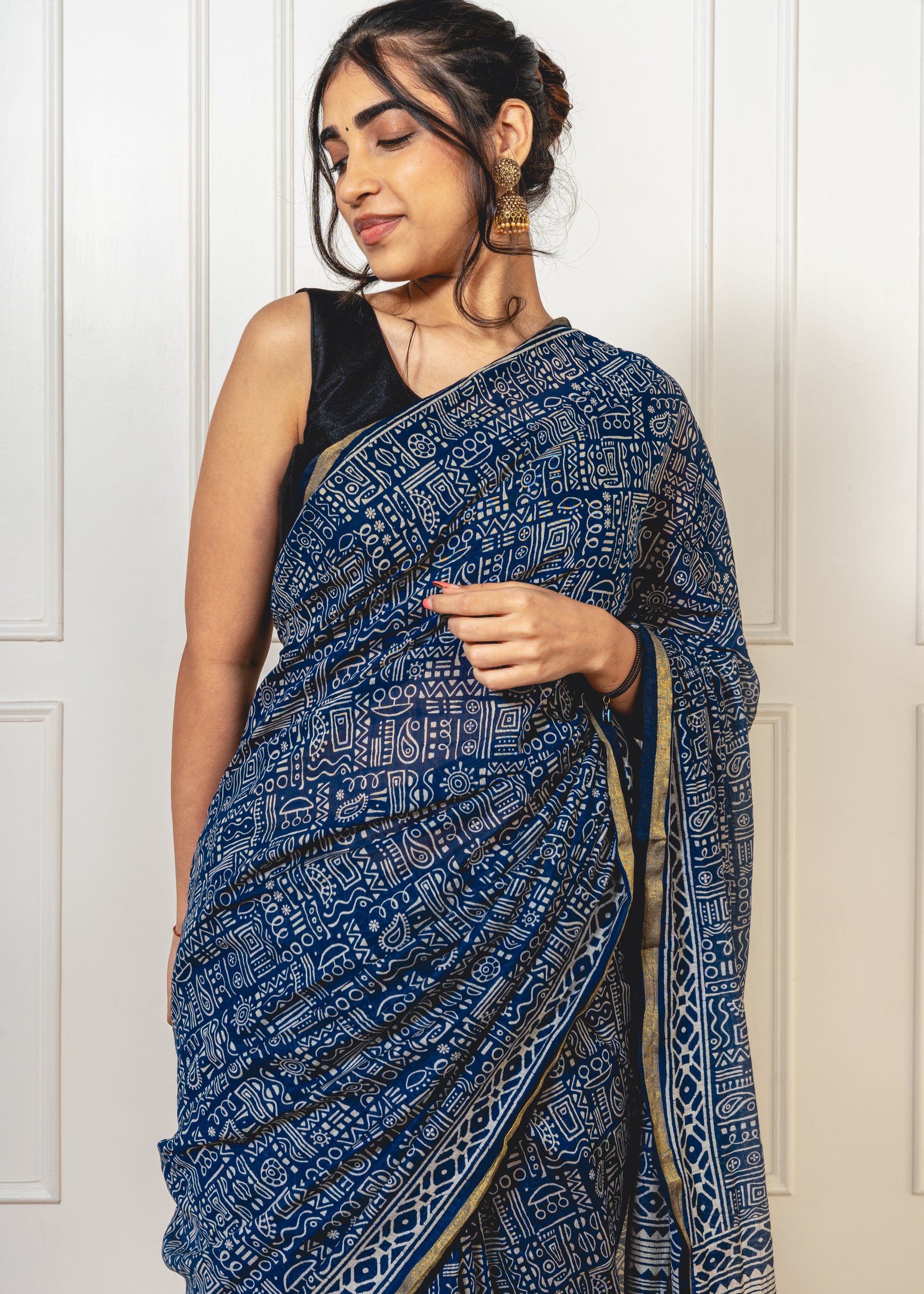 Blue Chanderi saree with Warli-printed pallu—capturing folk-inspired design and lightweight drape.