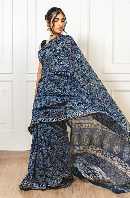 Woman wearing blue Chanderi cotton saree with Warli print—styled for festive grace and cultural charm.
