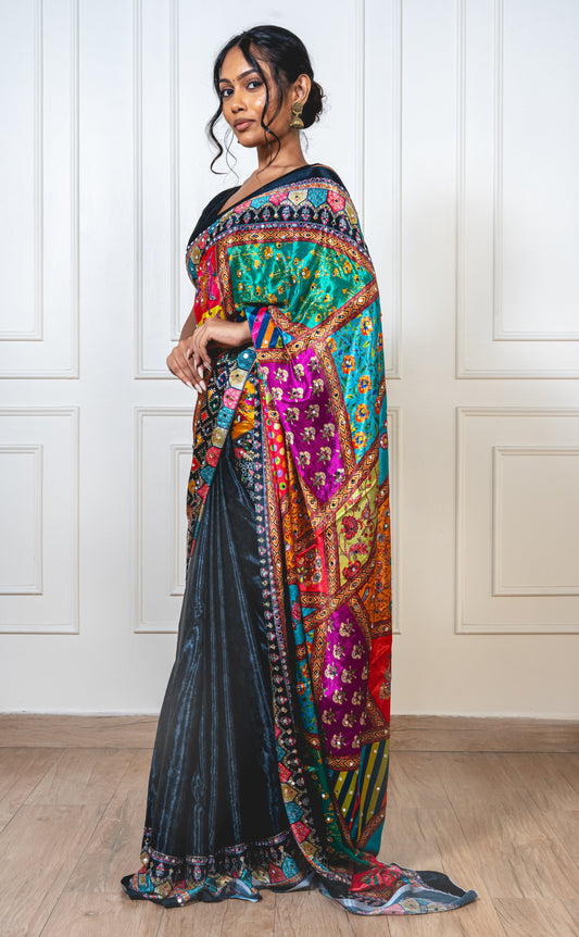Woman wearing raven black Chinon silk saree with mirror work—styled for Navaratri garba nights, pujas, and festive celebrations.
