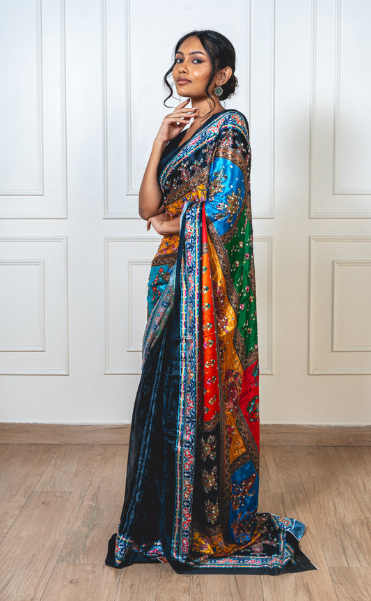 Woman wearing charcoal black Chinon silk saree with mirror work—styled for Navaratri garba nights and festive elegance.