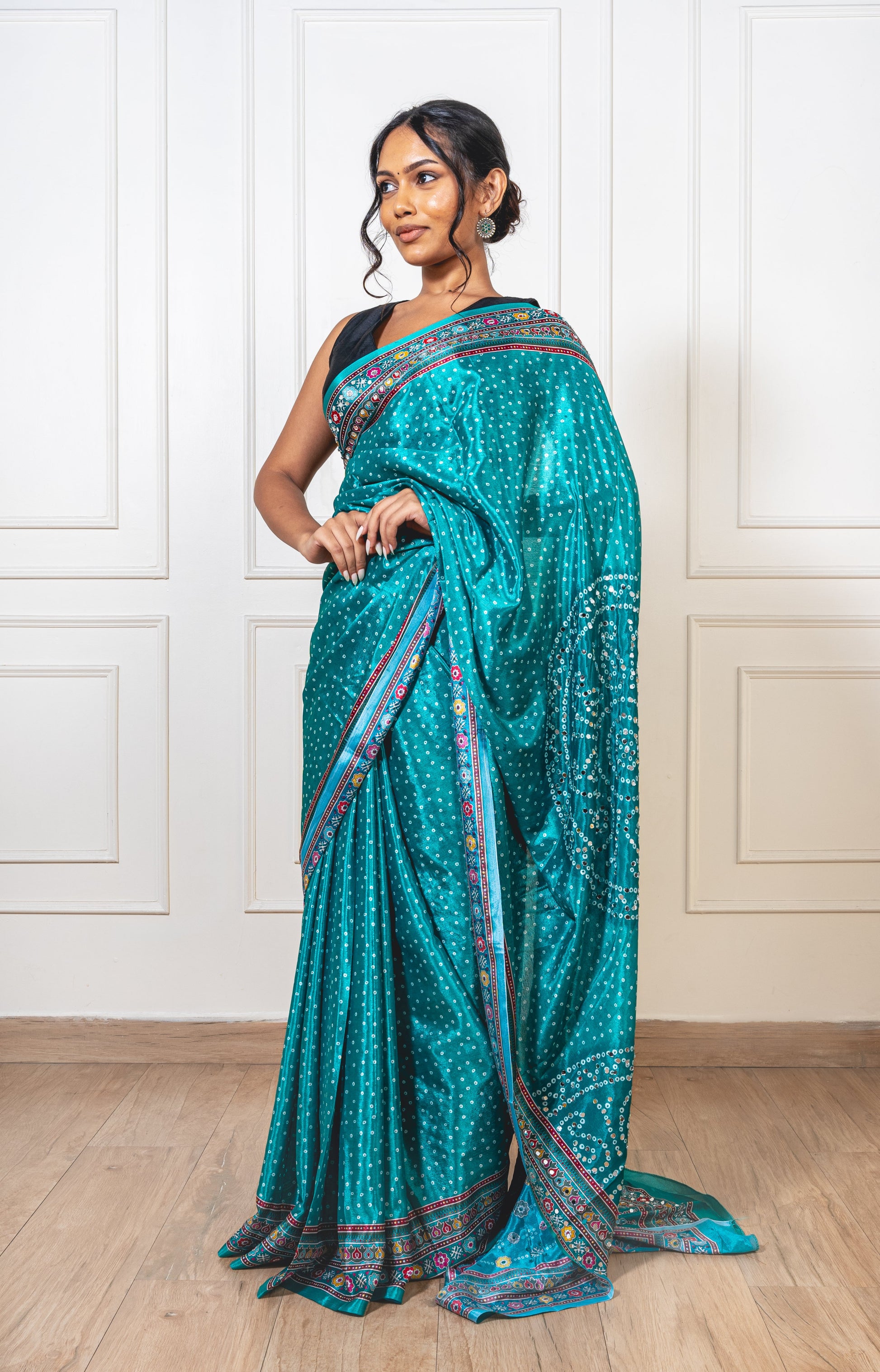 Woman wearing Tiffany blue Chinon silk saree with mirror work—styled for Navaratri garba nights, pujas, and festive celebrations.