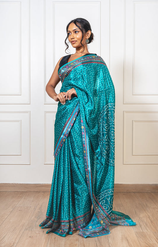 Woman wearing Tiffany blue Chinon silk saree with mirror work—styled for Navaratri garba nights, pujas, and festive celebrations.