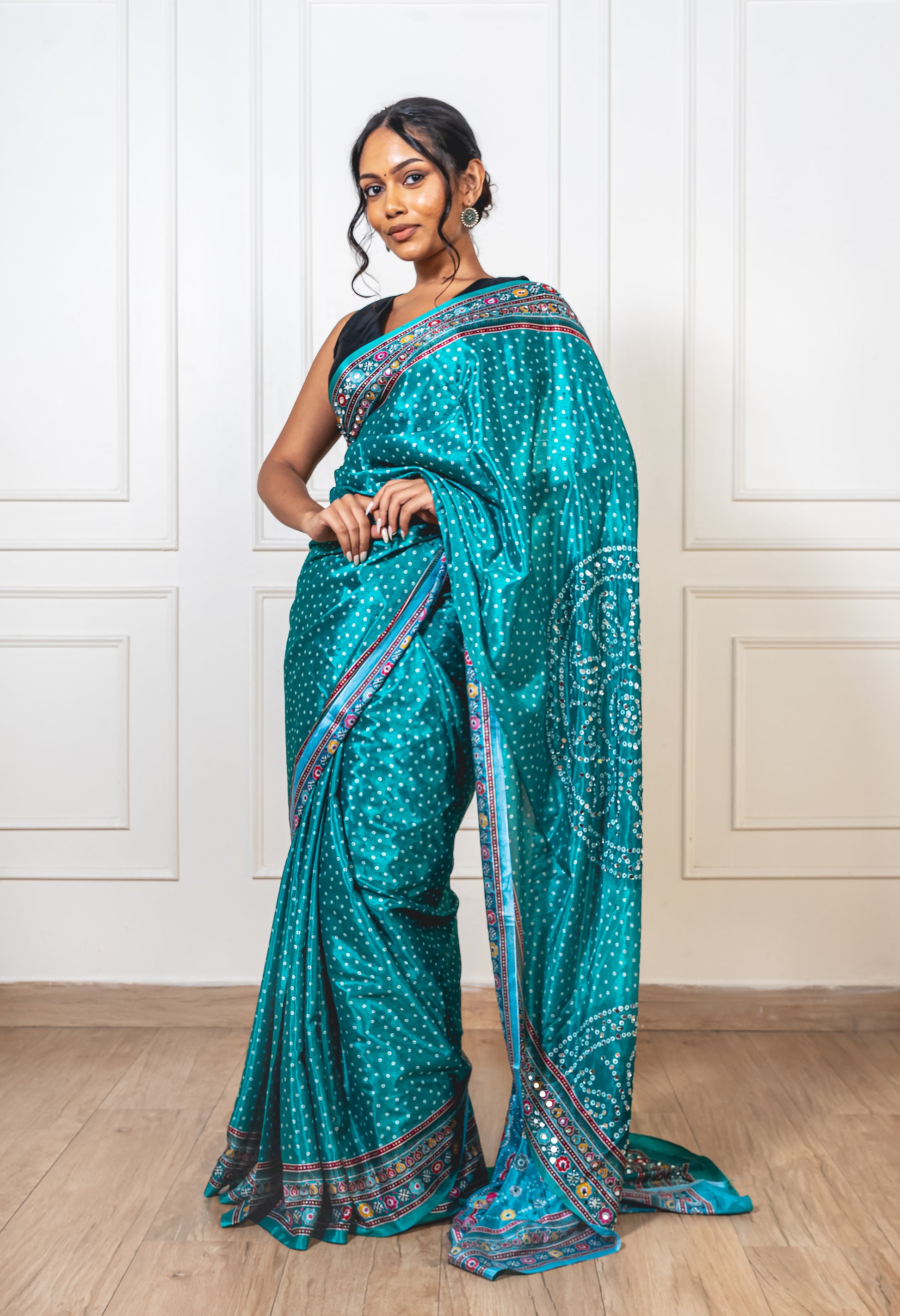 Tiffany blue Chinon silk saree with mirror-detailed pallu and crisp pleats—capturing festive shimmer and graceful movement.