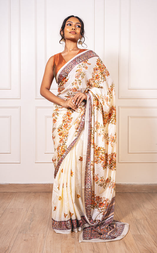 Woman wearing floral white Chinon silk saree with mirror work—styled for Navaratri pujas, garba nights, and festive elegance.