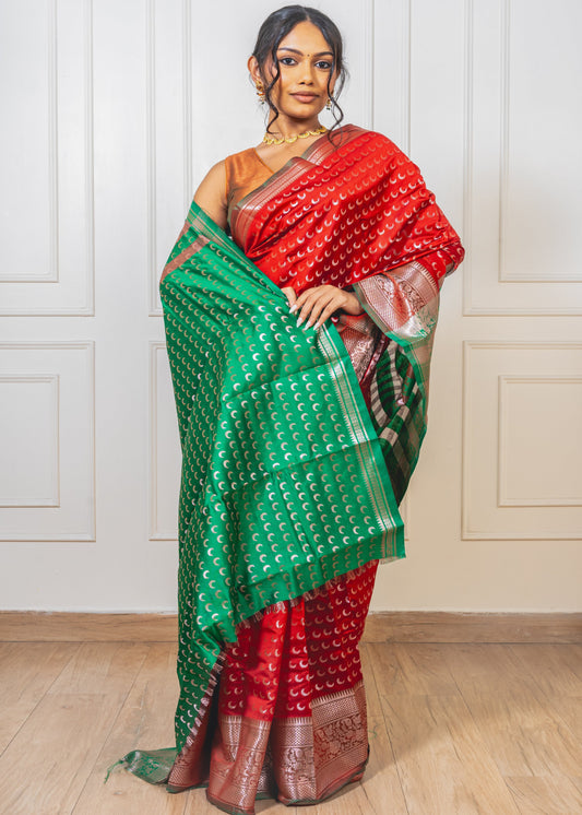 Woman wearing red Chandrakor Butta saree—styled for festive grace with crescent motifs and elegant drape.