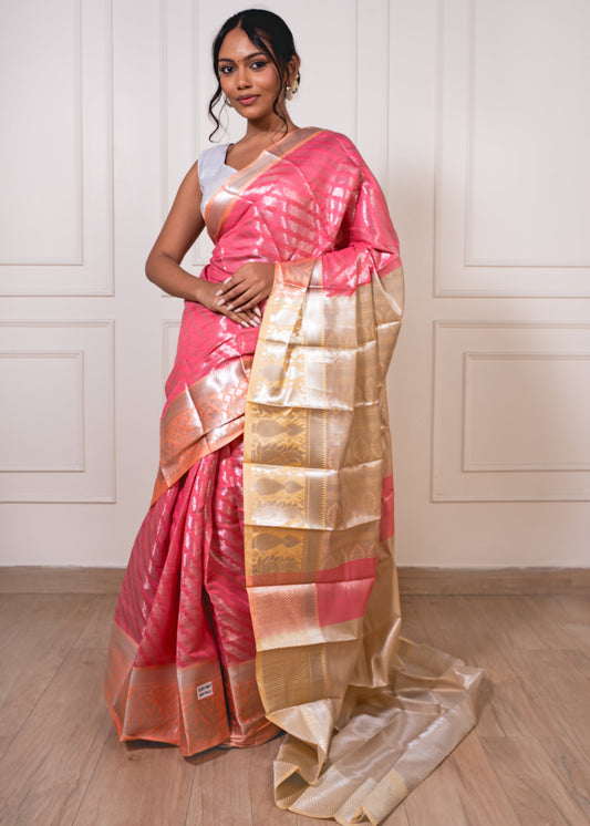 Woman wearing peach semisilk saree with beige border and silver zari—styled for light rituals, graceful gatherings, and timeless elegance.