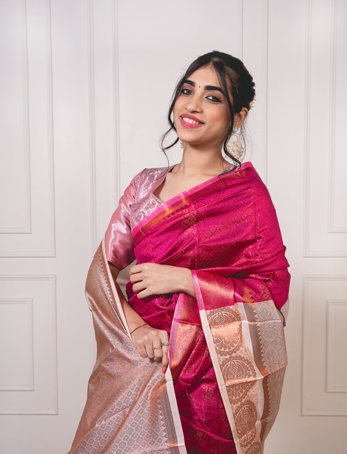 Close-up of copper zari weave on dark pink semi-silk saree—highlighting shimmer, fine craftsmanship, and soft texture