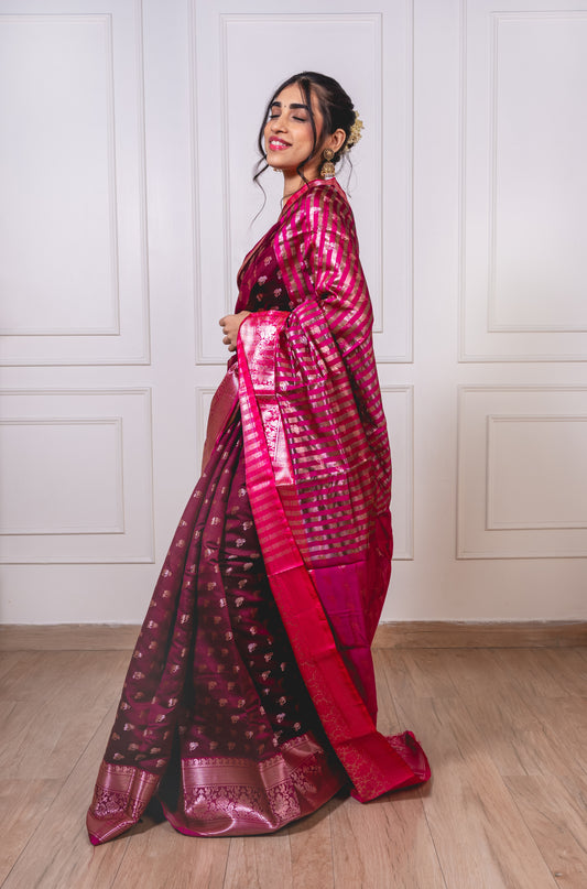 Woman wearing soft semisilk saree with woven Reshim Nath butta and broad Reshim border—styled for festive rituals and graceful gatherings.
