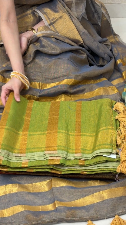 Woman displaying Light Green Khadi Tissue Saree in golden tones, exuding festive elegance and grace