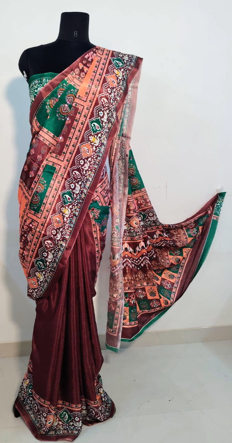 Brown Chinon silk saree with mirror-detailed pallu and crisp pleats—capturing festive shimmer and graceful drape.