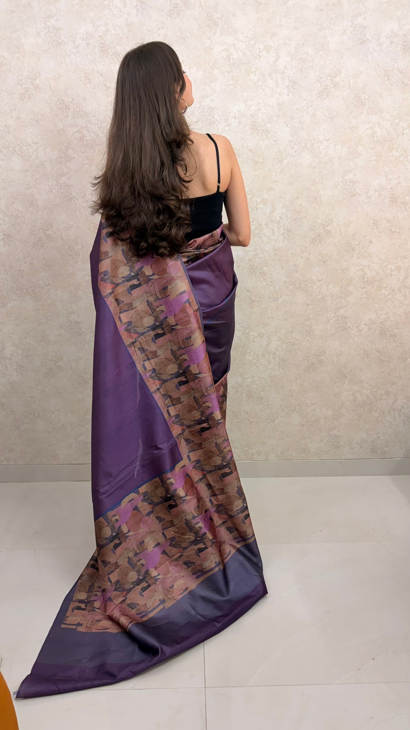 Female model showcasing Art Silk Saree with modern abstract border and graceful drape