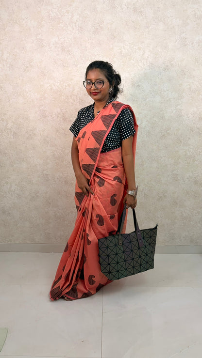 Model draped in Orange Cotton Silk Saree featuring artisanal block prints and elegant texture