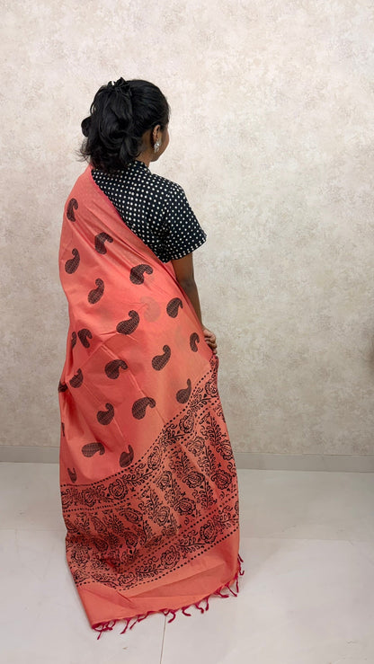 Graceful pose in Cotton Orange Silk Saree with detailed block print design and soft sheen