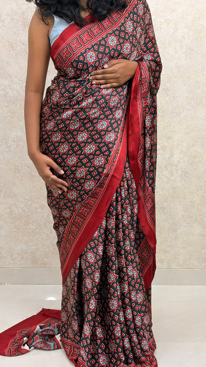 Saree-clad woman in Ajrakh Twilight Modal Silk, exuding timeless charm