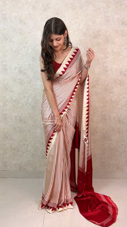 Woman wearing Modal Silk Saree with vertical stripes in cool tones, styled for a modern festive look