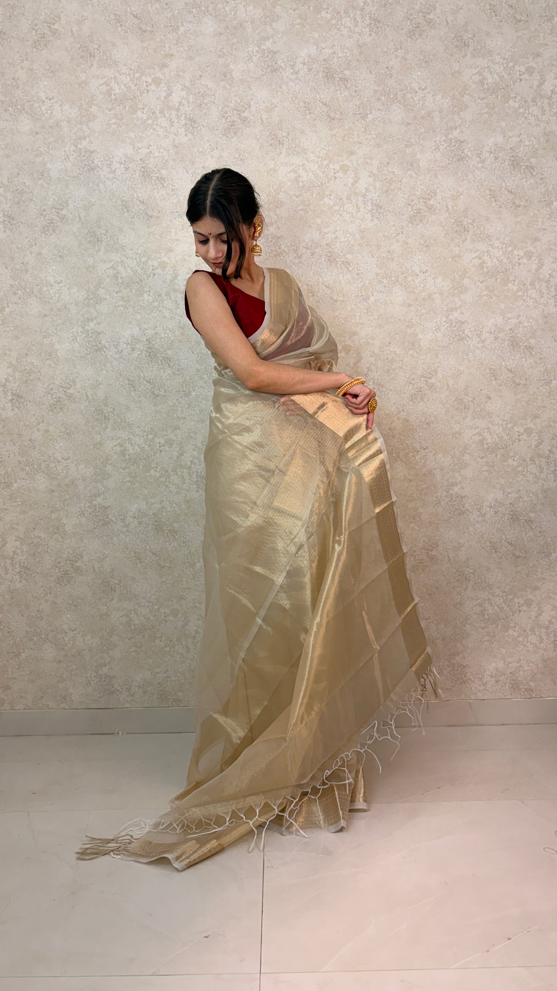 Woman wearing Golden Tissue Saree with Banaras Weave, exuding regal elegance