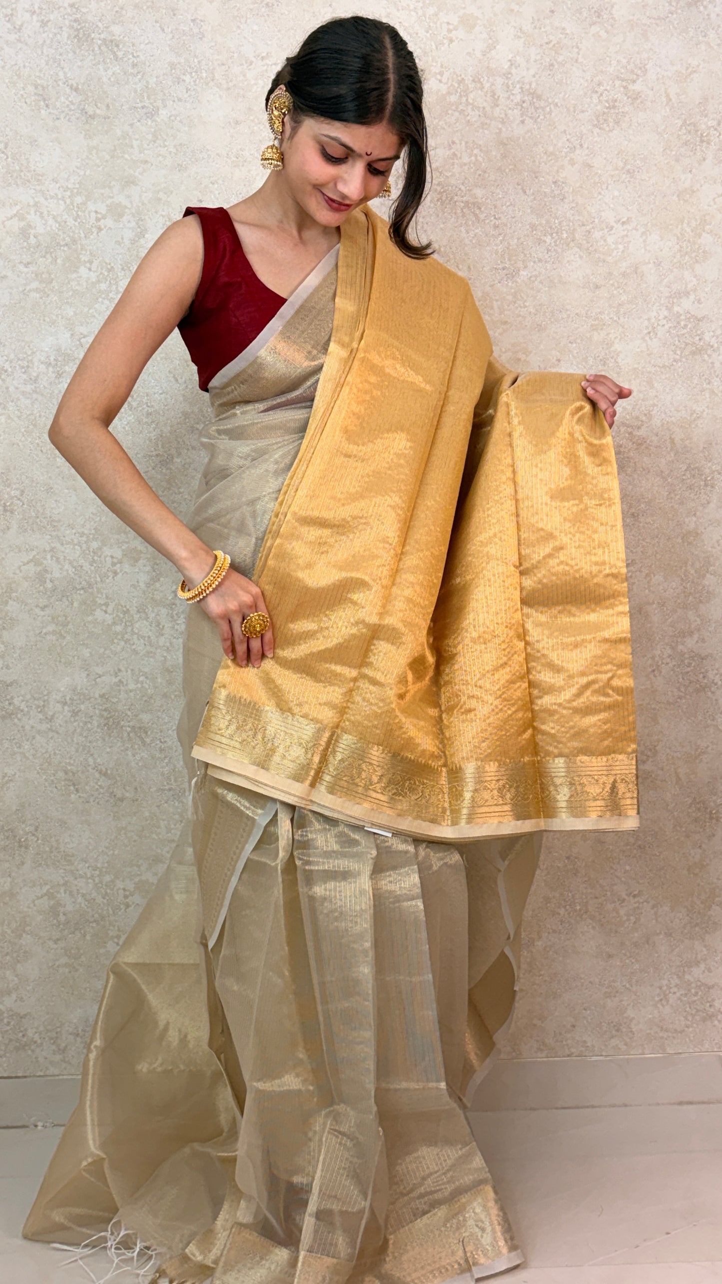 Graceful pose in Golden Tissue Saree with Banarasi craftsmanship and rich texture