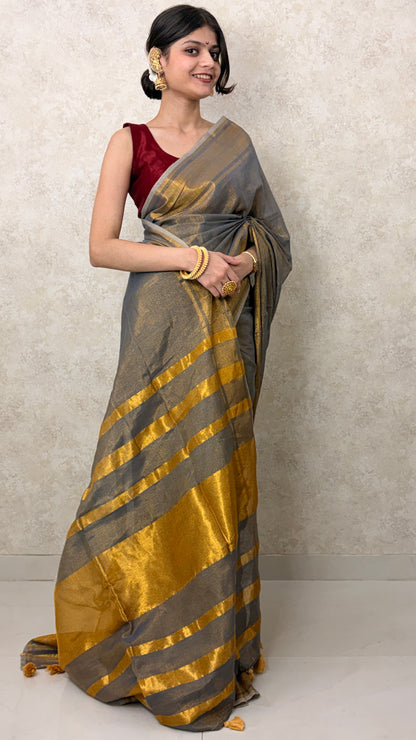 Elegant woman in Khadi Tissue Saree with golden shimmer, styled for a celebratory occasion